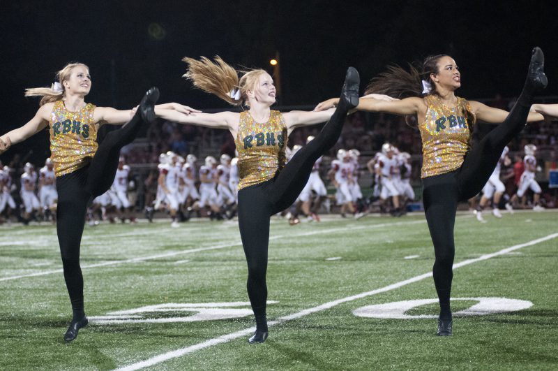 Junior Anna Kate Sundvold, sophomore Delaney Fuller and junior Brittany Hayes perform at half time on Sept. 22, 2018 at a game against Jefferson City High School. Photo by Maya Bell.