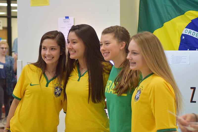 Four friends pose for a picture in front of the booth representing Brazil. Photo by Allie Pigg. 