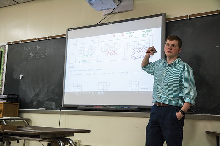 Adding up the knowledge: Math teacher Evan Thornberry works questions on the board in his Algebra 2 class Friday, April 27. Photo by Annalisa Geger.