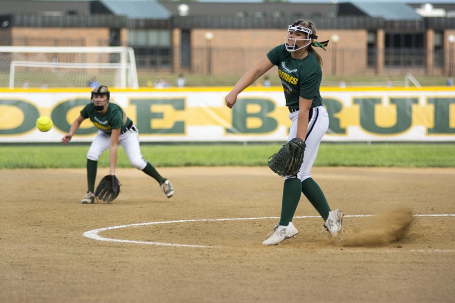 Senior Gemma Ross pitches to members of her own team during the Green and Gold scrimmage game on Aug. 23. Photo by Maya Bell