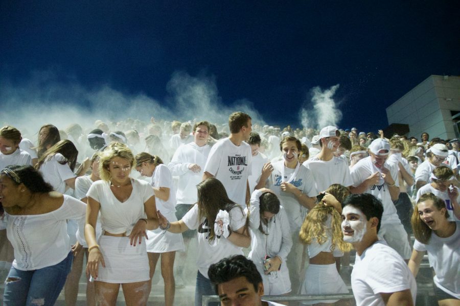 More than 350 students clad in white were in the BruCrew section where some students released flour though Dr. Jennifer Rukstad, principal, had told them not to. Photo by Bailey Stover