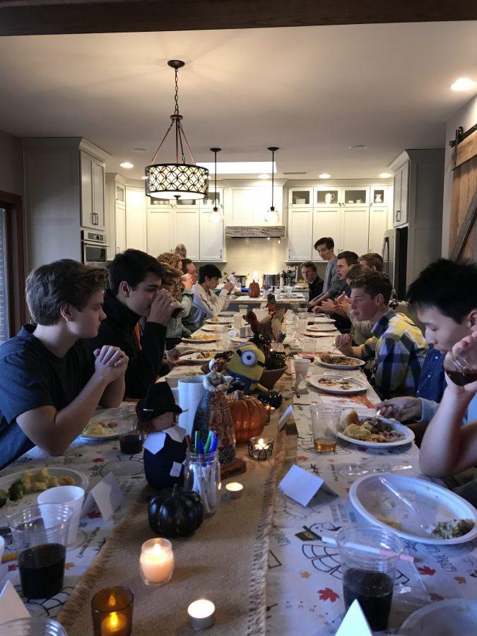 A group of 24 close friends gathers around a table to share lunch on Friday, Nov. 16. This tradition is known as Friendsgiving. Photo by Allie Pigg.