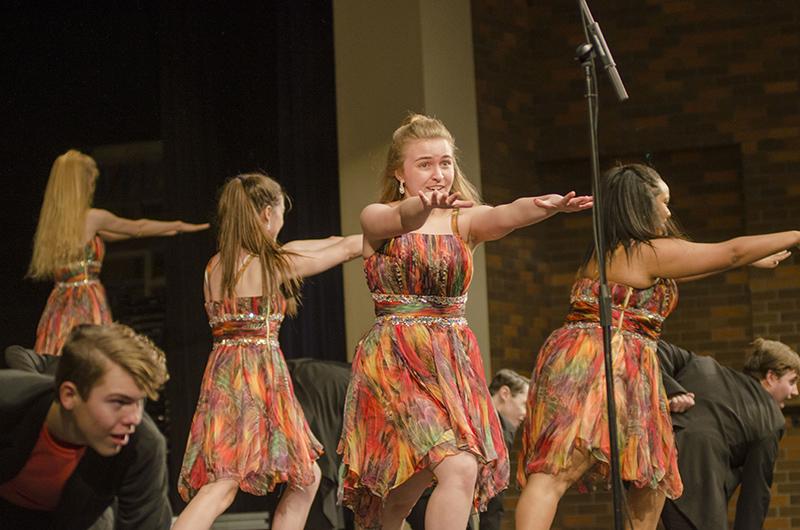 Junior Allison Whittom extends her arms out as the final pose of City Lights performance. The show is upbeat and exciting to any audience. The show choir will kick off its competition season next Saturday, Jan. 19 in Pleasant Hill.