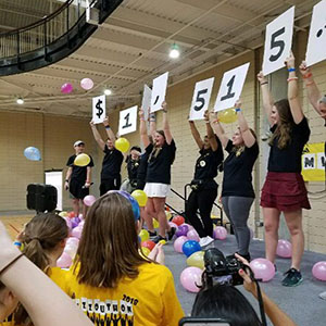 A photo from the Bruinthon event last year. Students show the amount of money they raised for the event.