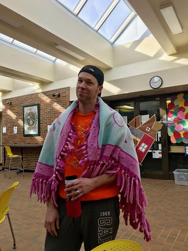 English teacher Greg Irwin stayed comfortable in his sweats with a blanket wrapped around him. He said he dressed up as a snuggly 37-year-old father of four. Photo by Allie Pigg