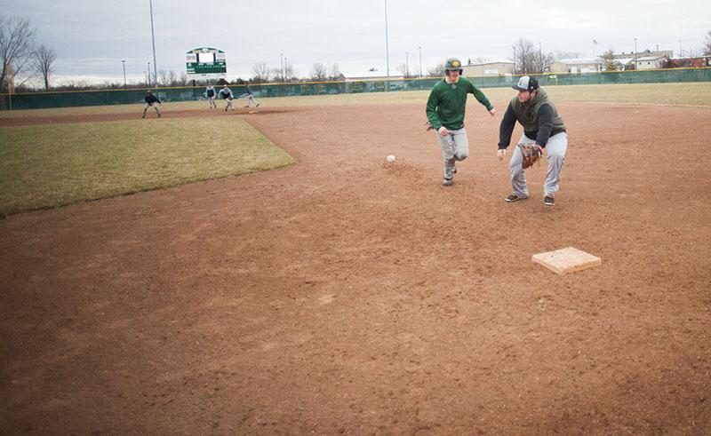 Sophomore Braeden Morris races to first base while sophomore Tucker Frost runs to make a catch Thursday, March 14. The team has a tournament, Best of the West, today at Barlett, Ten. Photo by Camryn Devore