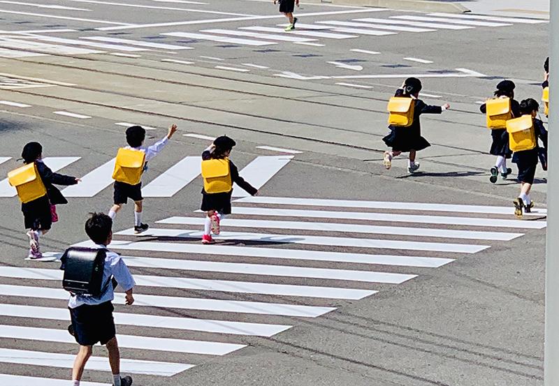 Kindergarten students run across the street in Toyama, Japan, in order to catch the train home from school.
George Frey / Bearing News