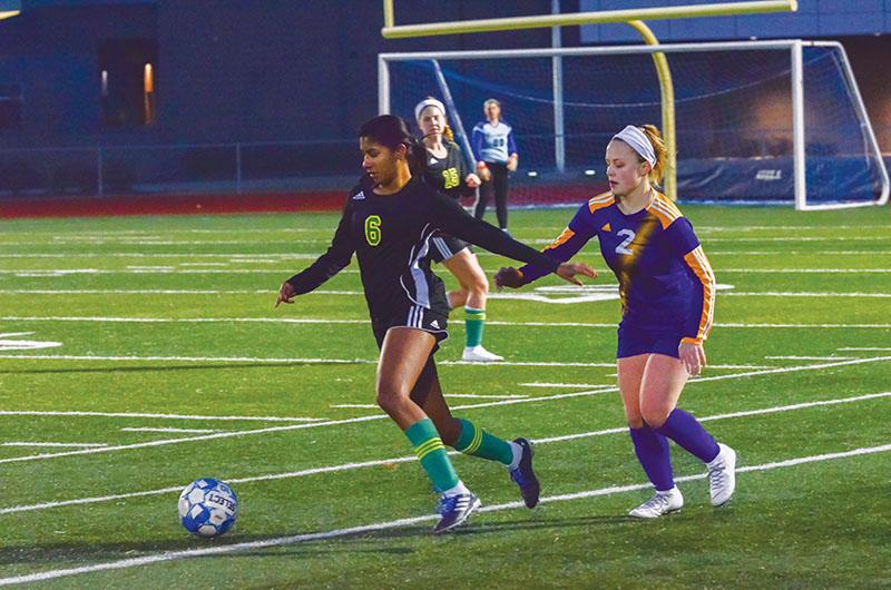 BREAK AWAY: Senior defender Lily Abraham takes off during the jamboree game against Hickman High School (HHS) Friday, March 8. The Bruins ended the scrimmage with a (1-1) draw. The jamboree was the first time the team played under new head coach Scott Wittenborn. Photo by Camryn Devore