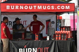 Burnout mugs engineer Michael Merwin shows off his innovative coffee tumbler, colling hot beverages to a drinkable temperature in the 93 degree Roots N Blues heat on Sept. 29. Photo by Audrey Snyder.
