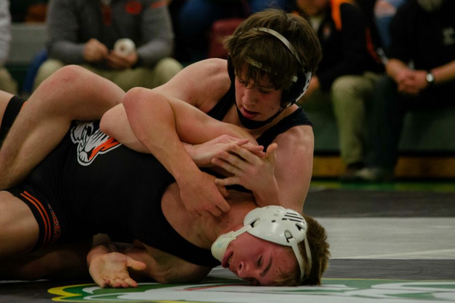 Sophomore Owen Twaddle pins Kirkville opponent Gavin Robertson (12) at the RBHS Wrestling Tournament, Dec. 7. Photo by Ana Manzano