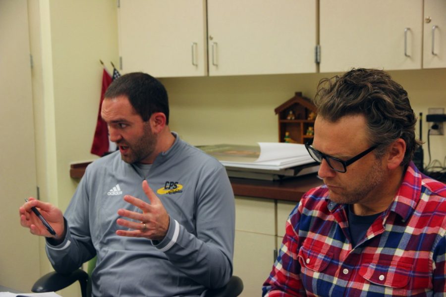 Current RBHS Athletic director and assistant principal David Egan, left, and current civics studies teacher Michael McGinty, right, converse during a meeting. (Photo by Audrey Snyder)