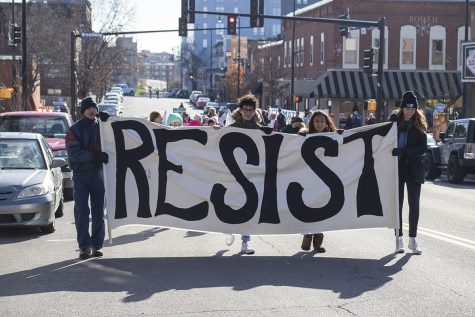 Students march with other community members. From left to right marched juniors, Isaac Yontz and Tia Rawat, and sophomore, Rachel Stevens. They held their sign with the word resist printed on it for the entirety of the womens solidarity march. Photo by Sarah Mosteller.