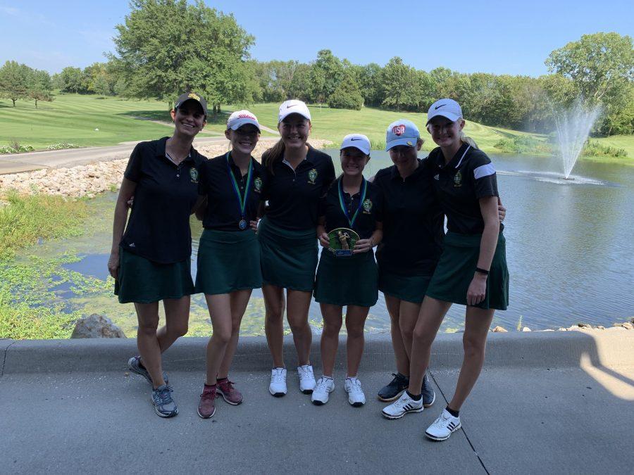 The Bruins pose for a team picture after the Lady Jaguar Invitational on Sept. 3, holding their trophy and sporting individual placement medals.