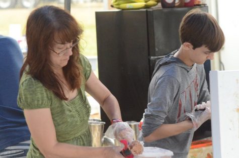 Clysta and Brandon Schettler scoop ice cream during the Roots N Blues festival Saturday, Sept. 28. Photo by Bailey Stover.