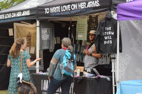 To Write Love On Her Arms worker Chad Moses speaks with festival goers during Roots N Blues Saturday, Sept. 28. Photo by Bailey Stover.