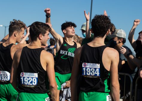 Wearing number 1929, senior Matthew Hauser celebrates his Missouri State High School Activities Association (MSHAA) state championship victory with his teammates and classmates in the crowd. Hausers point contribution pushed the RBHS boys team to first place in a tense meet. 