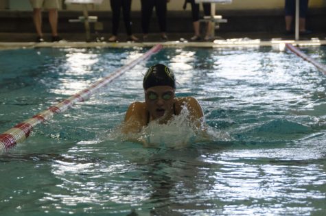 Senior Ansley Barnes glides through the breastroke leg of her 100-yard individual medley Feb. 8. Barnes swam the 100-yard individual alongside her friend and teammate Reagan Richards. The two were laughing through the race, barely getting enough air to continue swimming. Photo by Turner DeArmond.