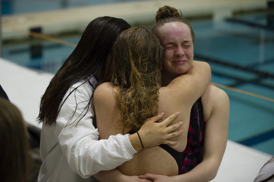 A misty-eyed goodbye: Juniors Mara Manion and Elise Henderson embrace senior Ansley Barnes following the conclusion of the meet. After realizing she would never be on a team with Barnes again, Manion broke into tears. Barnes and Henderson quickly hugged her and reassured one other they would always treasure the memories they shared. Photo by Turner DeArmond.