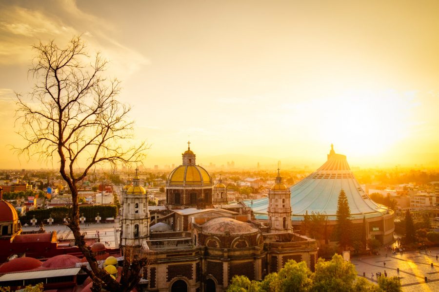 Scenic+view+at+Basilica+of+Guadalupe+with+Mexico+city+skyline+at+sunset%2C+Mexico.+Used+with+permission+from+Envato+Elements.