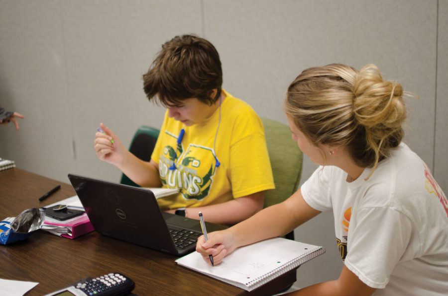 Finishing MyMathLabs, junior Halle Paulus helps a freshmen in her advisory class with their math homework. Paulus is the mentor in the class for Schirmers 3B advisory. Photo by Camryn DeVore.