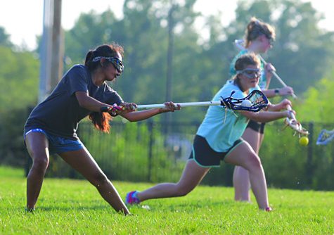 CHECK IT OUT: Sophomore Riya Amin (RBHS) and junior Holly Dickinson (Columbia Independent School) practice on Thursday, Sept. 19. Girls from all Columbia schools practice as a part of the Columbia Girls Lacrosse Organization. (Photo by Sarah Mosteller)