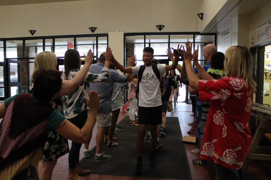 Sophomore Evan Holiday receives high-fives from teachers and staff as he enters RBHS on the first Friday of the 2019-20 school year. School for the 2020-21 school year will commence on Aug. 24th. Photo by Jadyn Lisenby