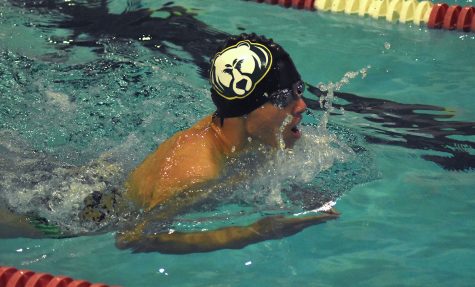 Junior Kenji Kuwajima makes his way down the pool in the 100-yard breastroke. Although freestyle is Kuwajimas best stroke, he decided to work on his breastroke at the meet. Committed to improvement, Kuwajima put his best effort into the race.