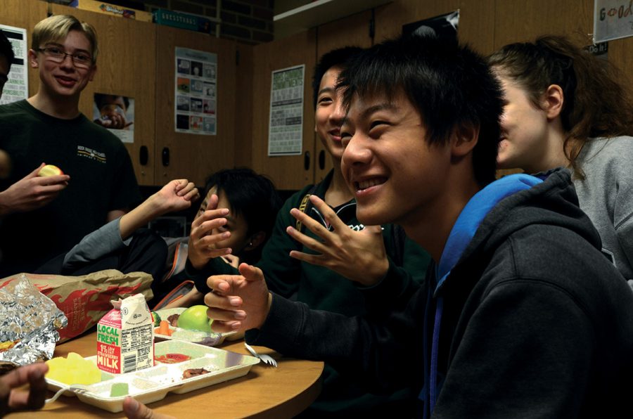 Juniors (left to right) Eric Fritschi, Dick Chen, Phillip Lei, Taisheng Li and Lola Gingerich laugh over their lunches in the EEE room Oct. 9. Students had just been released for A lunch, during which the EEE room is usually full. Photo by Turner DeArmond.