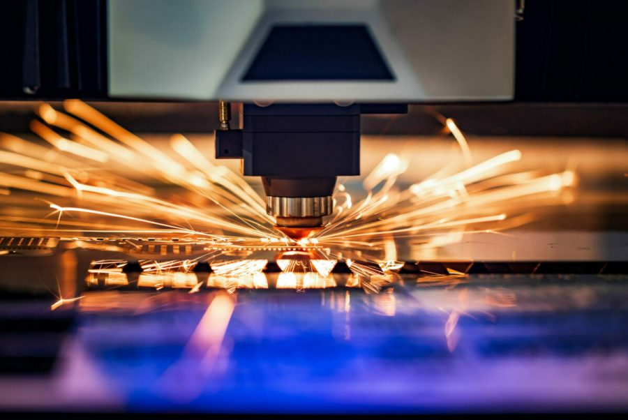 CNC Laser cutting of metal, modern industrial technology. Small depth of field. Warning - authentic shooting in challenging conditions. Photo from Envato Elements.
