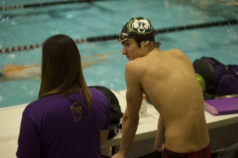 Sophomore Nick Clervi and head coach Taylor Birsa converse during the 20 minute break Nov. 16. In prelims, Clervi posted a time of 55.85 and placed 15th. In finals, Clervi achieved a time of 54.08 and placed ninth.
