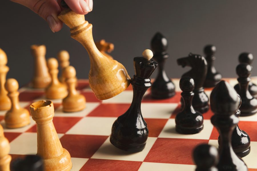 Plan leading strategy of successful business competition concept. Hand of player chess board game putting white pawn, copy space