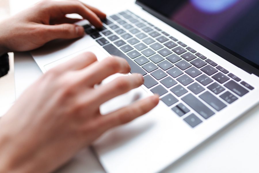 Close up photo of man hands typing on laptop. Photo from envato elements.