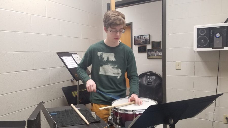 Quinn Spear practices percussion in a band practice room. Photo by Audrey Novinger
