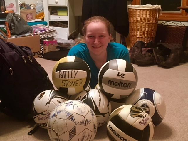 Bailey Stover sits on her floor surrounded by piles, shoes, volleyballs and soccer balls. This is her on the first day of quarantine. Photo by Robin Stover.