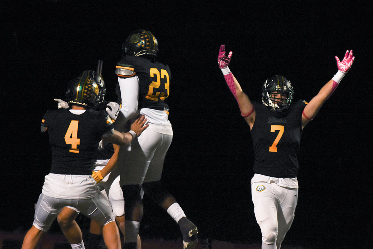 RBHS football players Crew Norden (11), Jeremy Woods (11) and Riley Rolwing (11) celebrate a touchdown at the homecoming game against Battle on Oct. 6. 