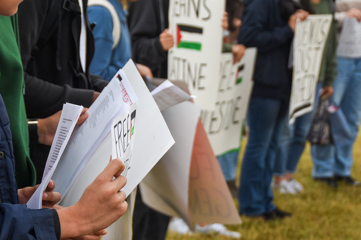 Photo of participants at the Free Palestine Rally holding posters advocating for US government support of Palestine. The Free Palestine Rally took place outside of the RBHS main entrance on Oct. 25.