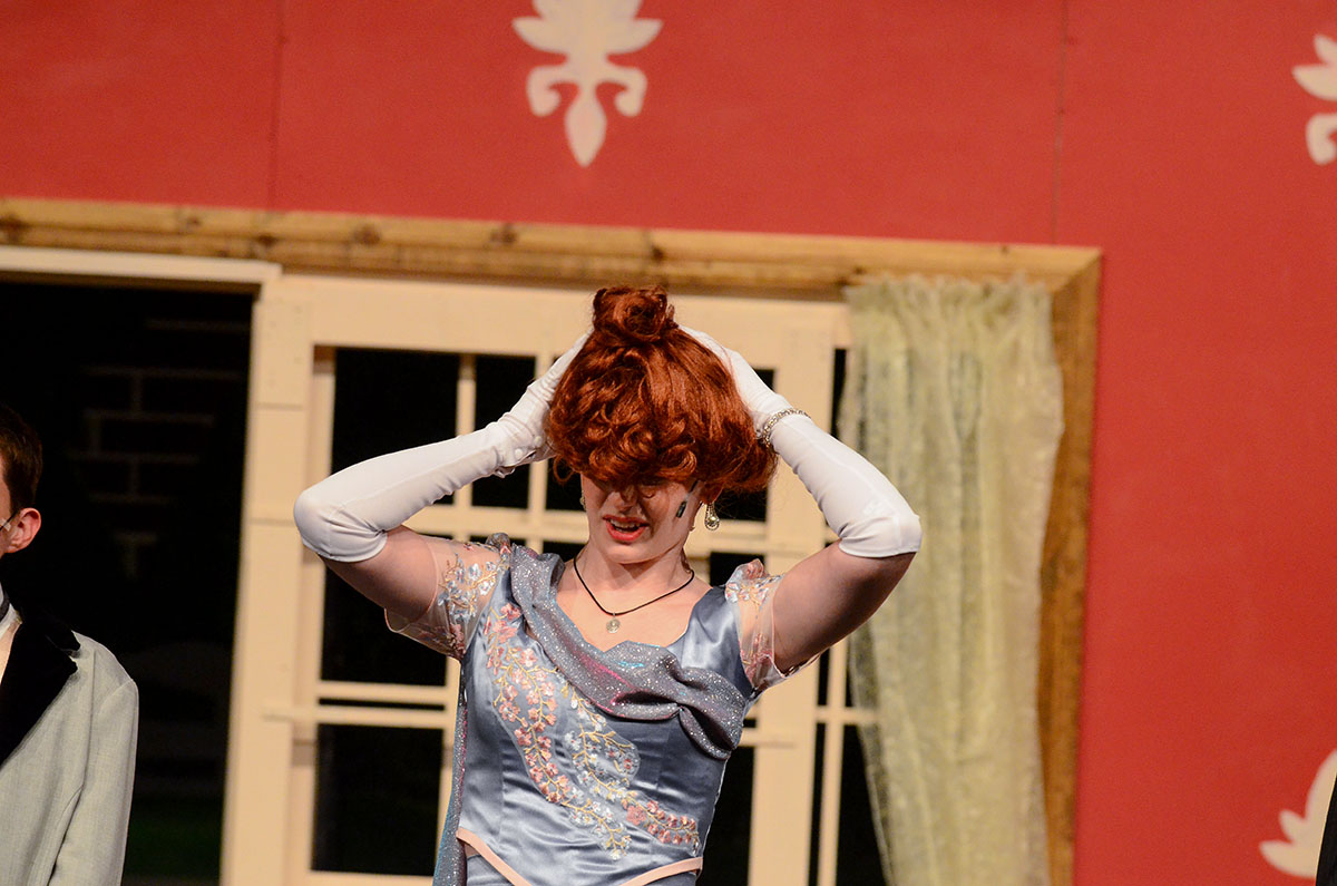 Violet Embry, played by Emily Ryan (12), fumbles with her wig. 