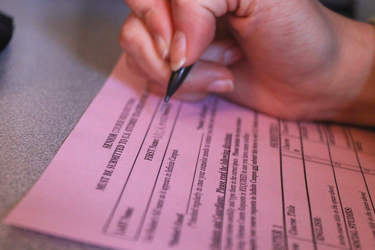 Photo of a student filling out the course registration form. 