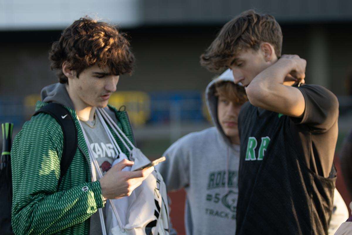 Riley Rolwing (11) and Brennan Scott (10) discuss how theyre going to execute the 200m dash.