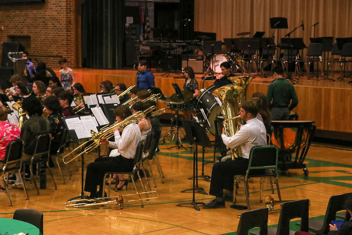 Photo of trombone and tuba section at the rehearsal for a band concert. 