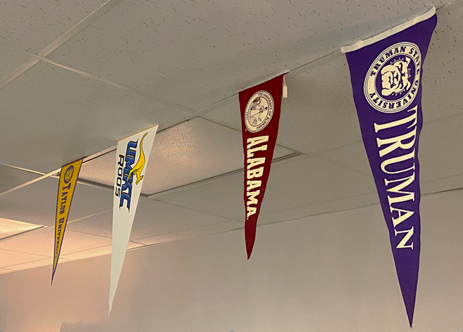 Flags in the counselors office, represent college choices in the United States. 