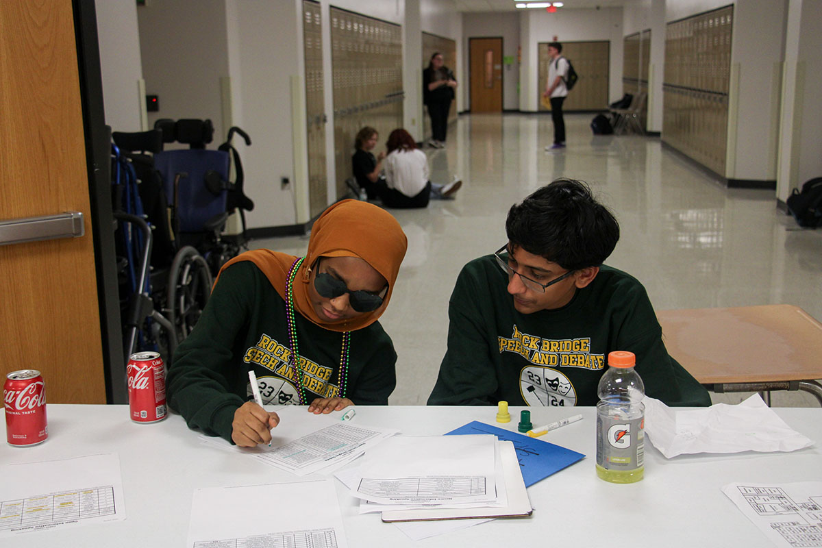 Ahlam Alamin (10) and Aneesh Calyam (9) run a check-in table during RBHSs annual debate tournament, COMO Classic, on Feb. 2.
