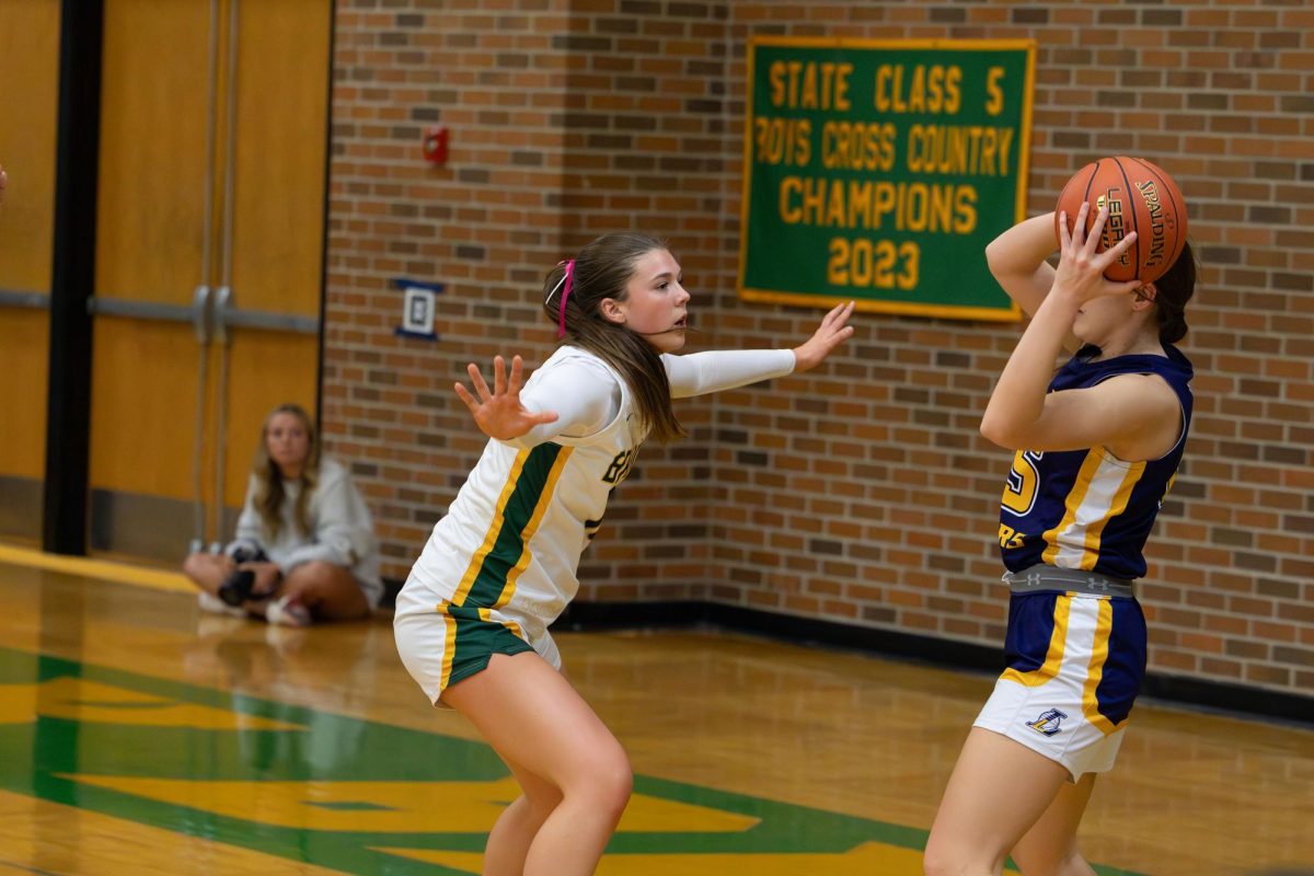 Cora Smith (12) guards the ball at the varsity girls' basketball game Feb. 19.