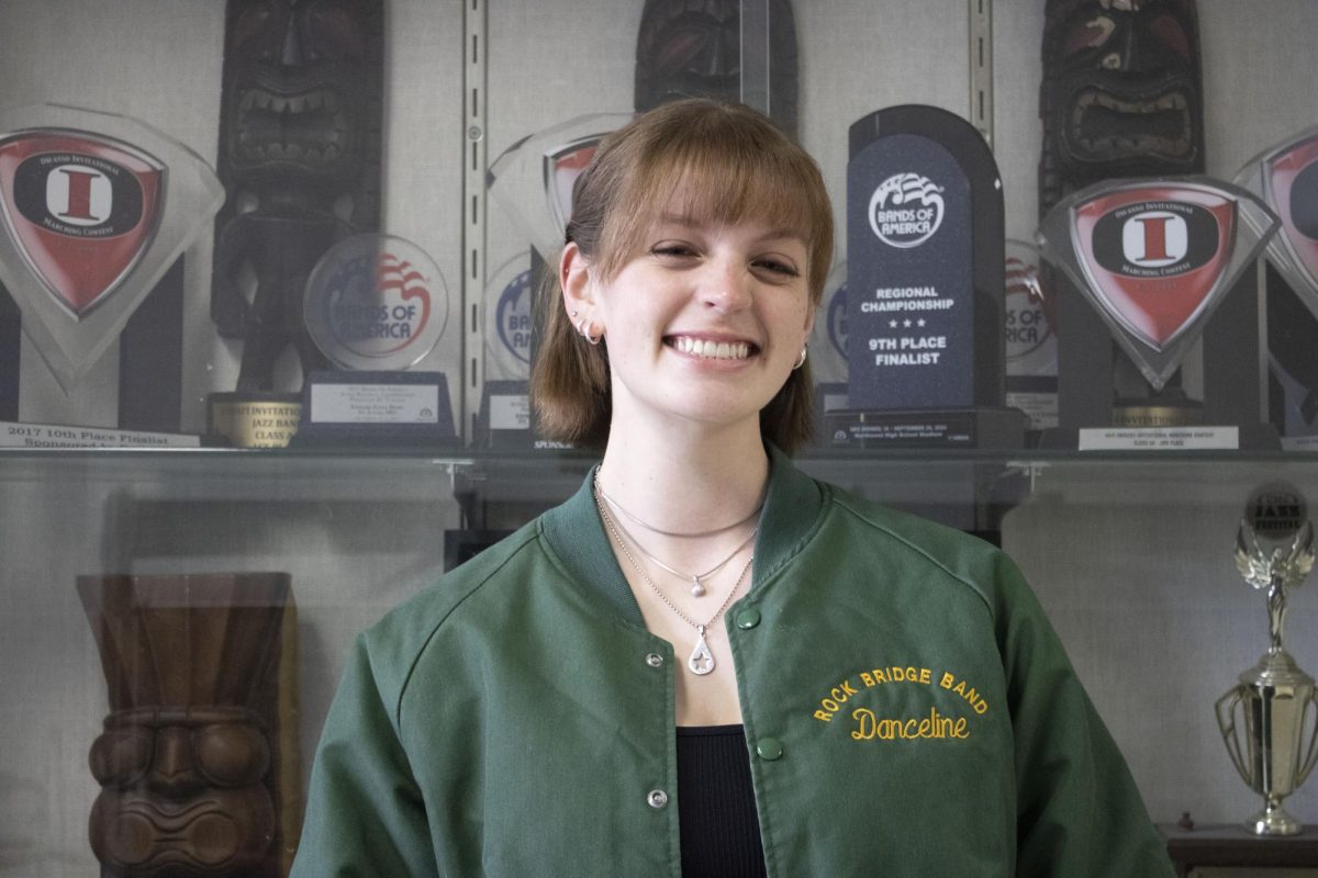 Standing in front of accomplishments made by fellow RBHS band students, Kara Morgan (12) is dressed up in a RBHS band jacket, representing her passion for fine arts. She participates in tons of band activities, such as marching band, show choir band, basketball pit band, and more! “Stay in band, please. The fine arts program at our school is shrinking."