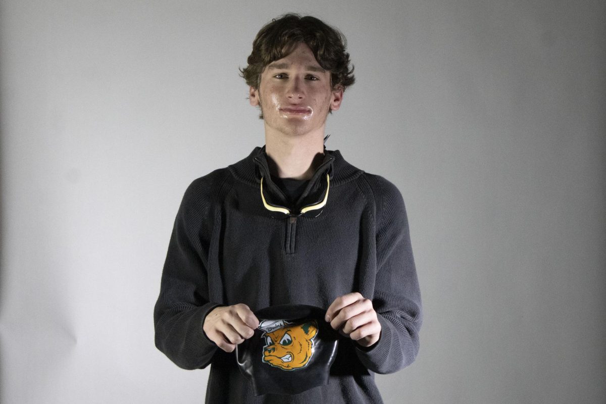 Holding out his cap, Patrick Wehner (12), reflects on his time as a Rock Bridge athlete. Wehner was ready to leave RBHS, but was also sad thinking about the things he would miss. “I think swimming and my friends,” Wehner said. “Swimming has brought so much. It's so fun.”